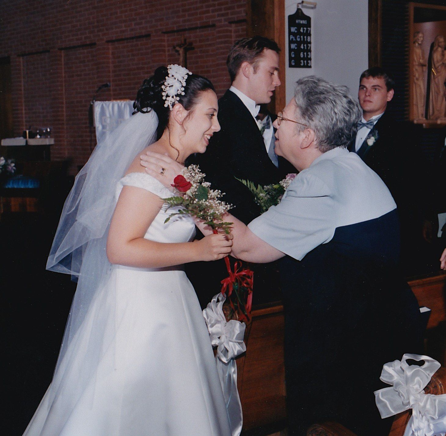 Giving my mother-in-law a rose as a partof our wedding mass