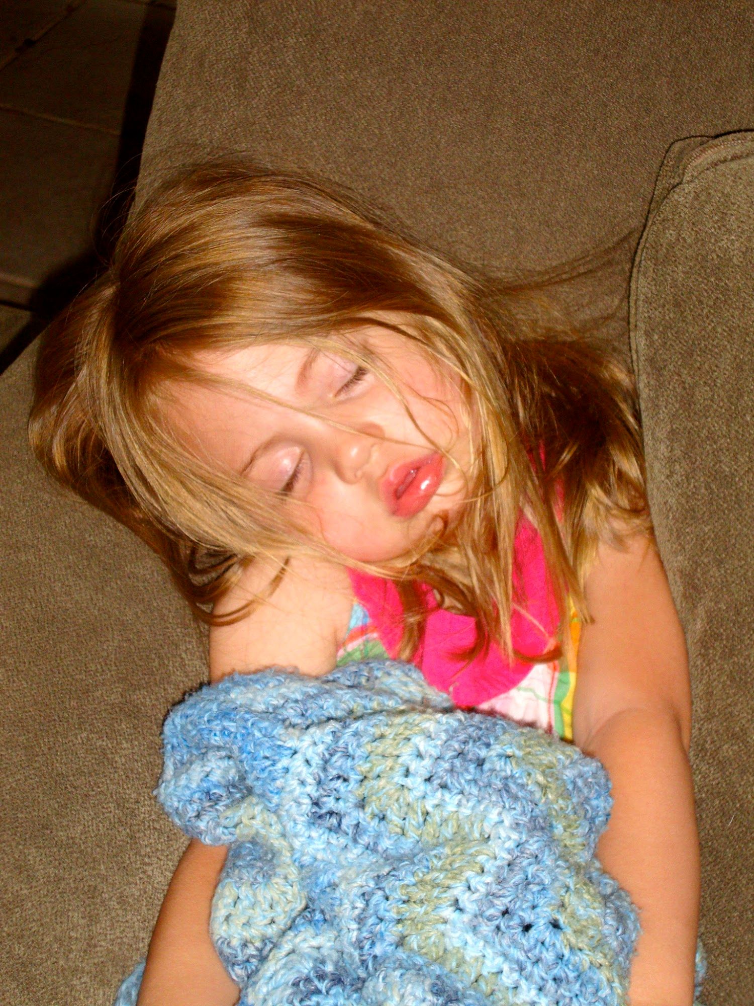  Age 2 1/2, sleeping upright in our chair and a half in our family room. 