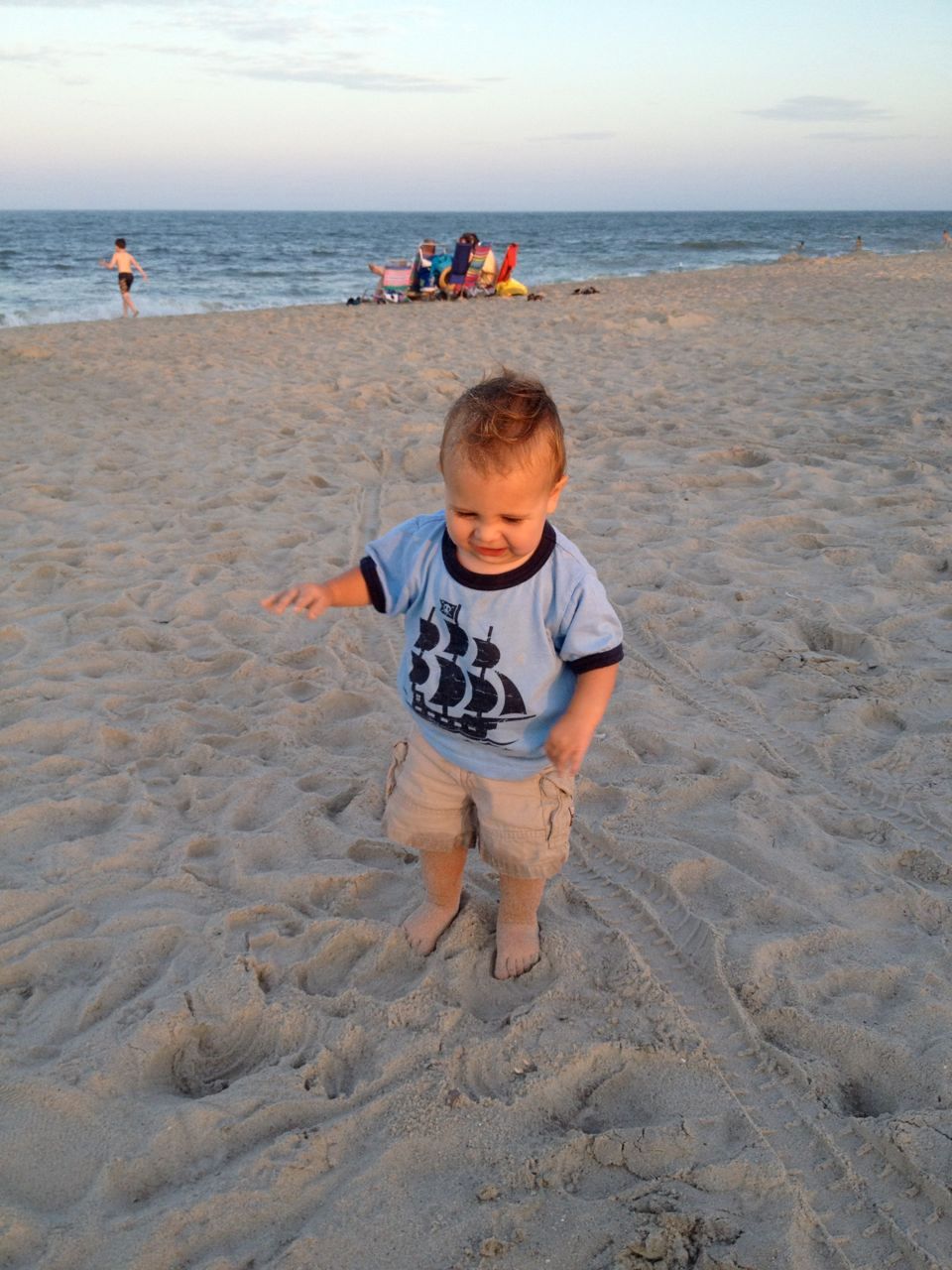  Feeling the sand between his toes. 