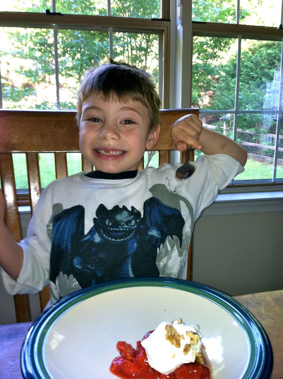  My favorite dragon trainer enjoying his first strawberry pie. Ahem, he refuses to eat strawberries.  That apparently went out the window when he harvested his own strawberries, from his own garden, and Mama made him a pie. 