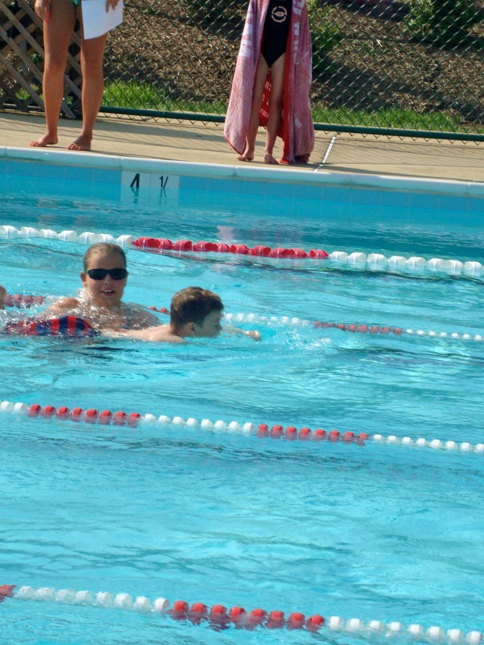 Swimming the freestyle event. The coaches are there in case the kids need them along the way. Phew!