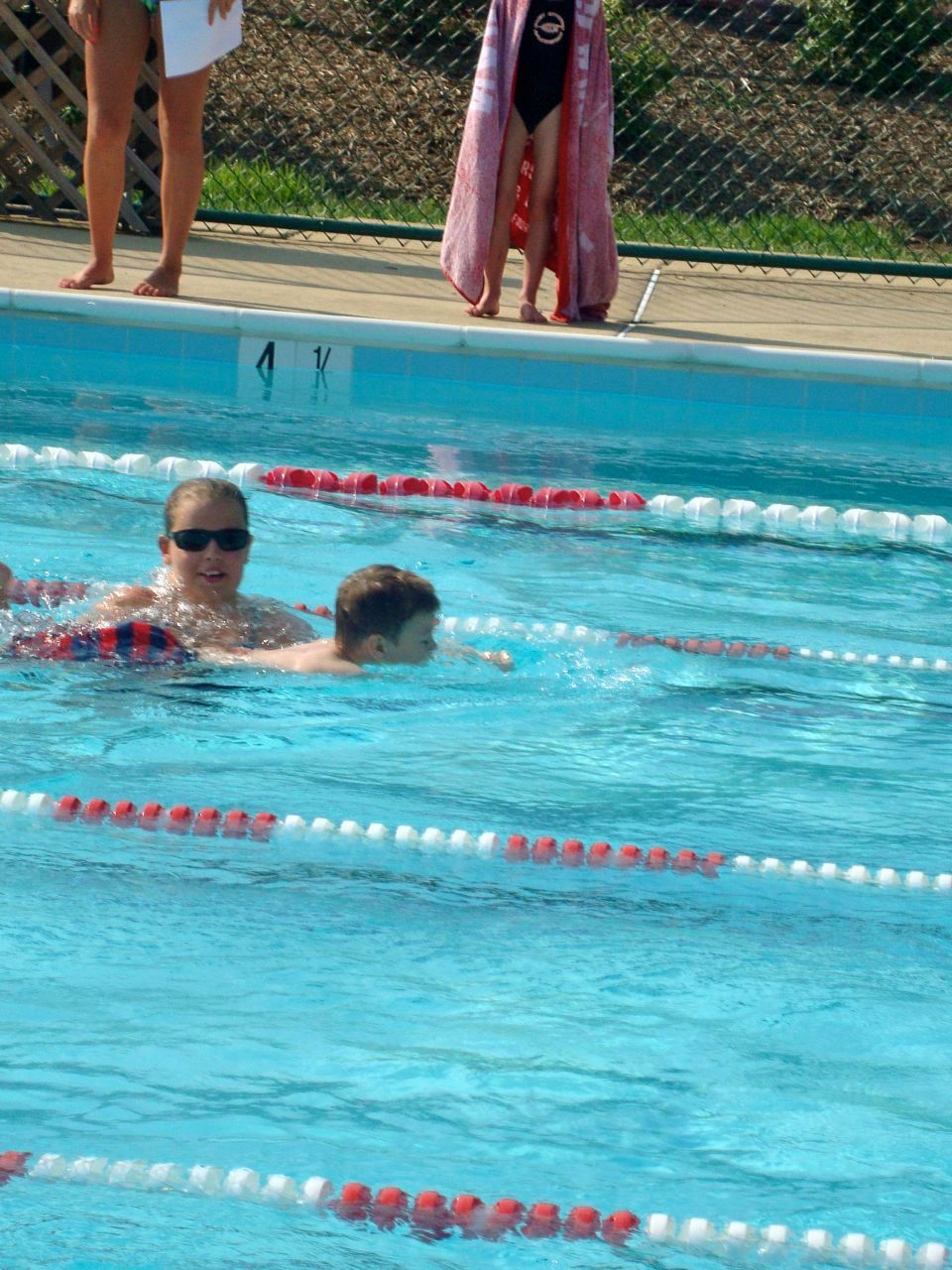  Swimming the freestyle event. The coaches are there in case the kids need them  along the way. Phew! 