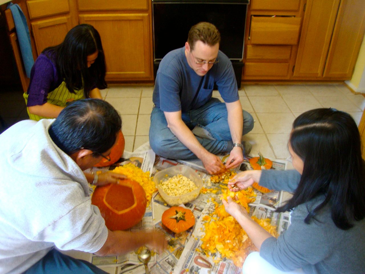 Cleaning out the pumpkins and setting aside the seeds to roast them