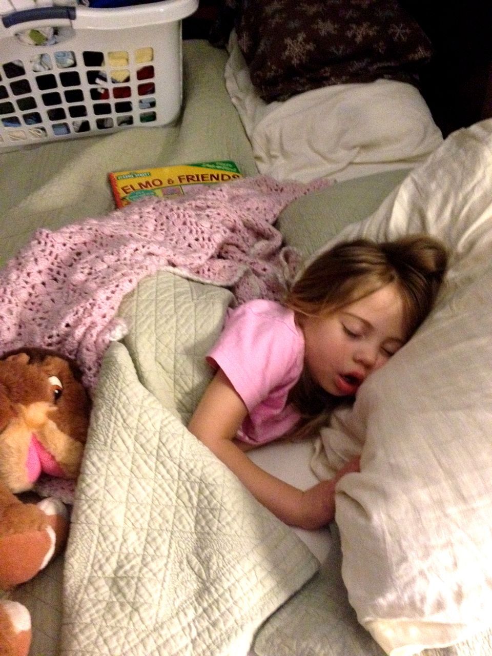  She's made herself quite cozy by bringing her Elmo book to bed, the pink blanket I made for her, and 