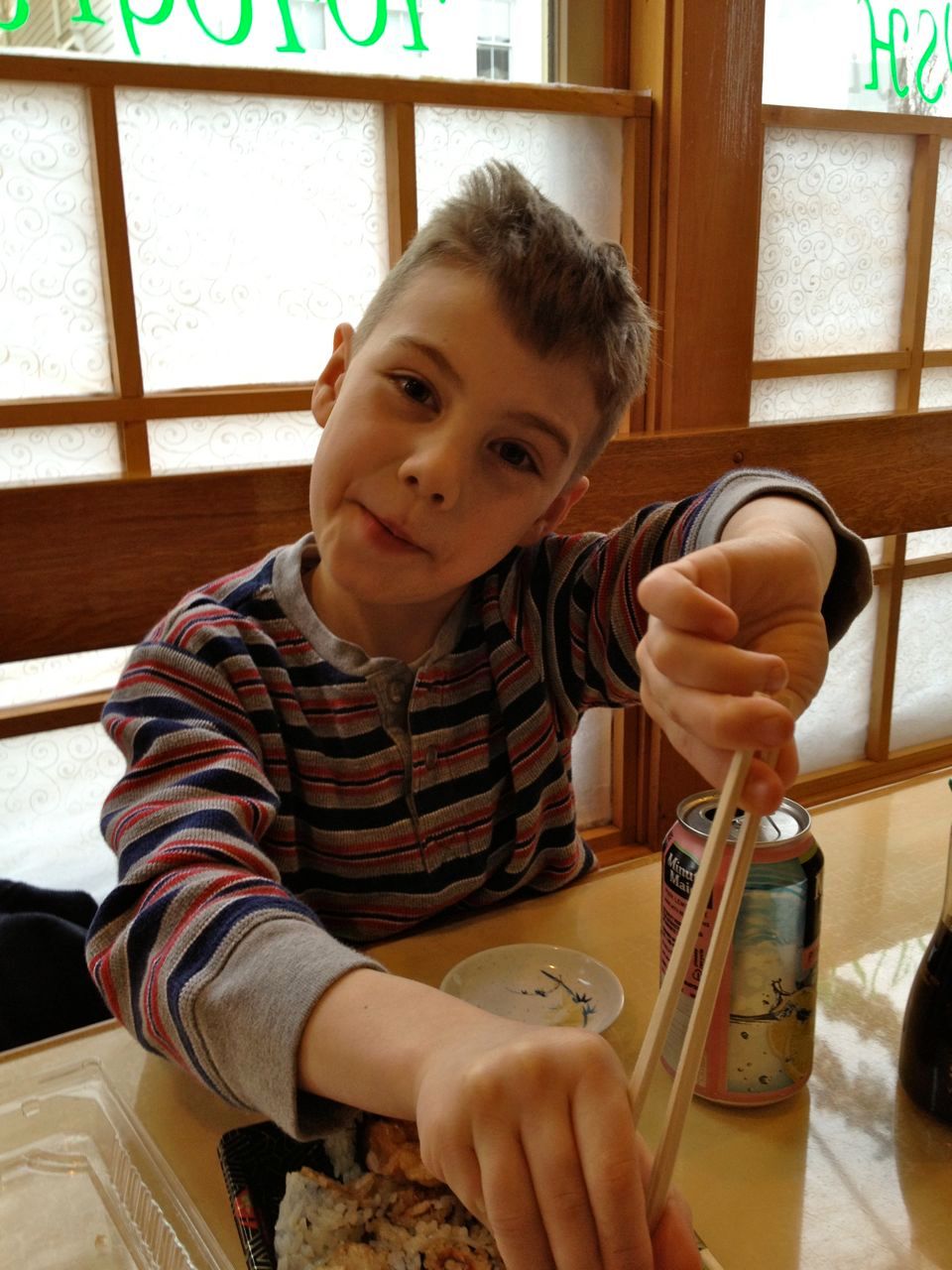 Using his chopsticks
