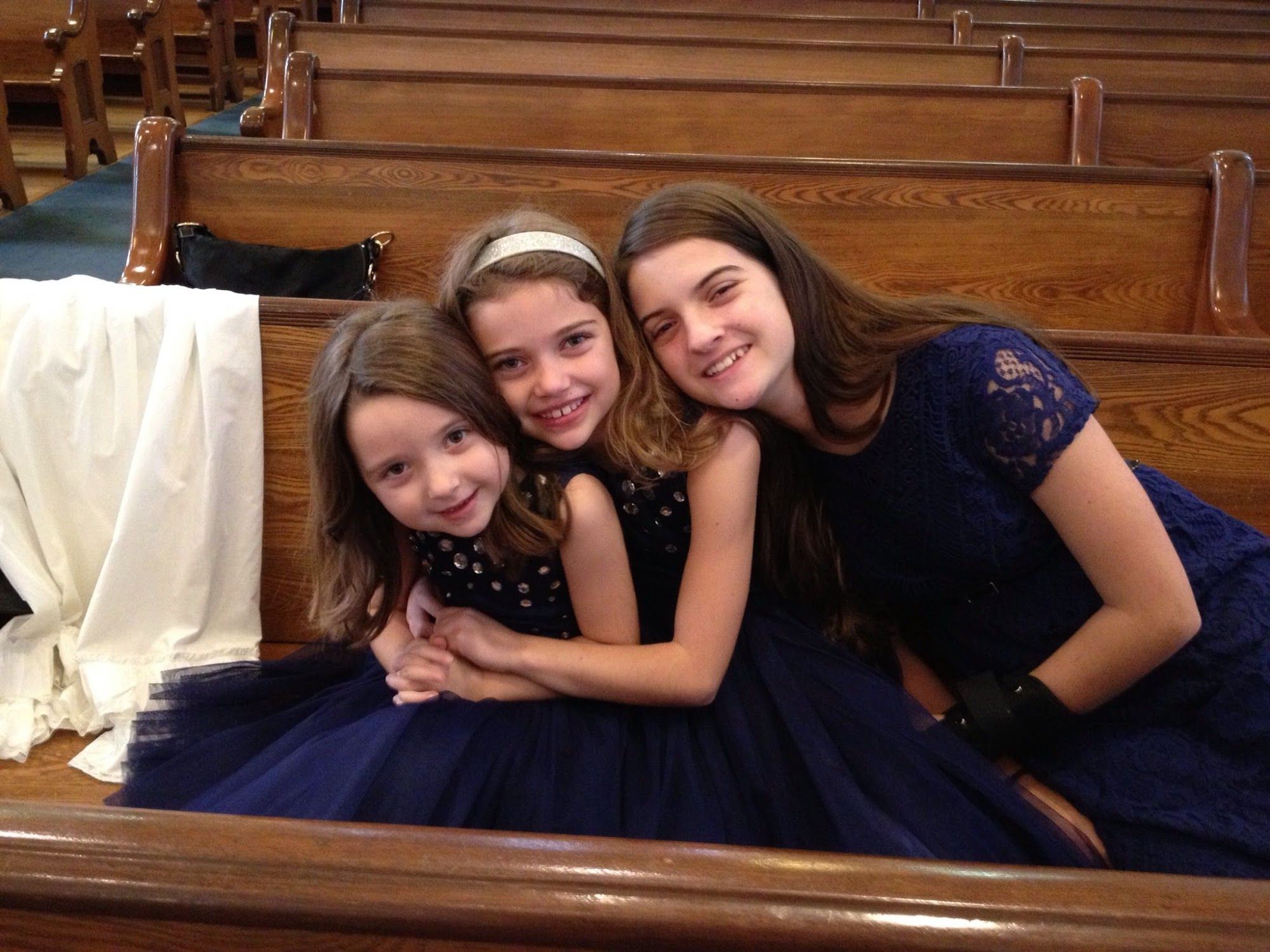 Three sisters getting ready for their sister's baptism.