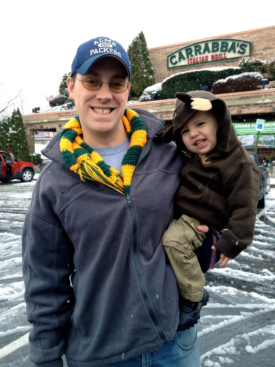 Hubby wearing his scarf while holding the cutest moose I've ever seen.Yes, those are antlers on Bananas' hood. Super cute!