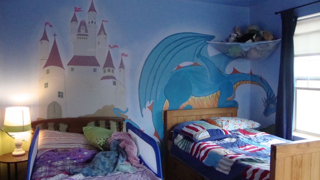 The mural framing the beds.