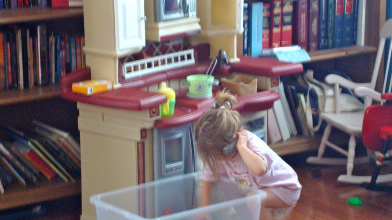 Buggy talking on the phone while she prepares